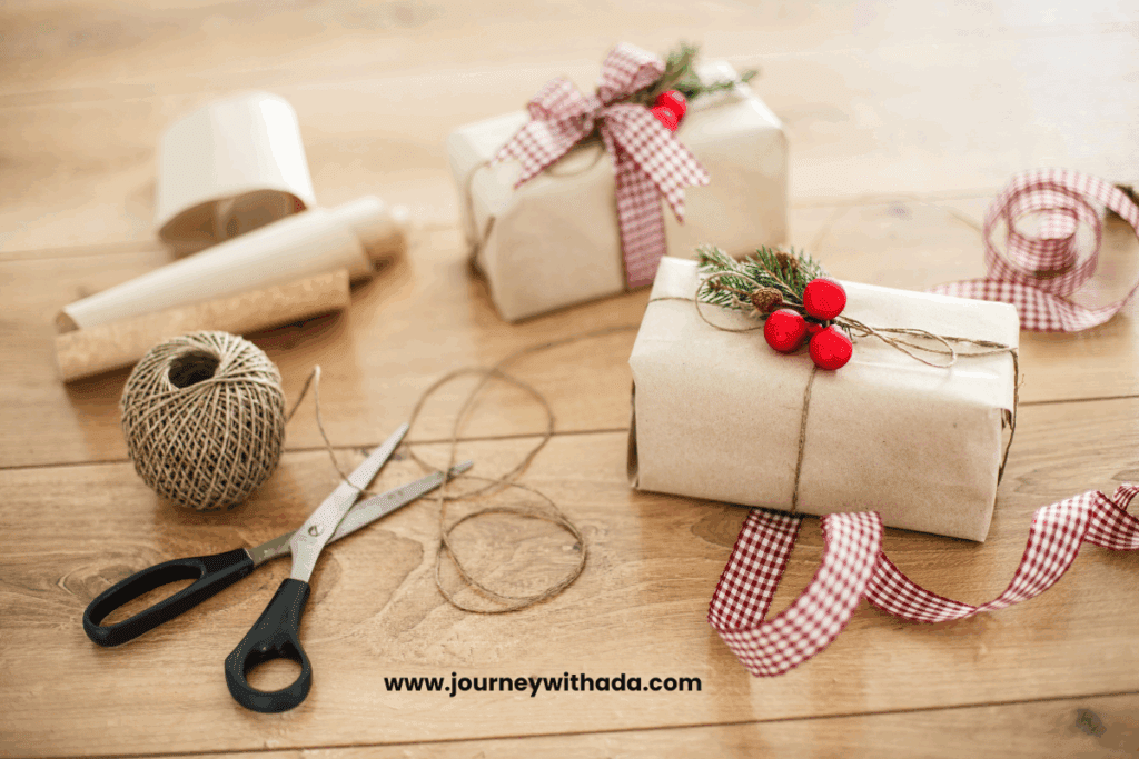"Flat lay of DIY Christmas gifts including handmade ornaments, painted mugs, and wrapped treats on wooden background